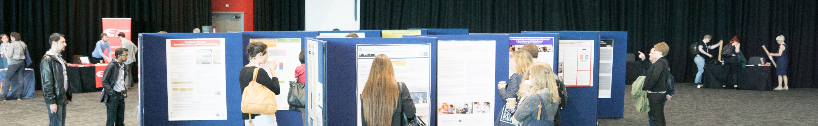 students looking at exhibition of posters